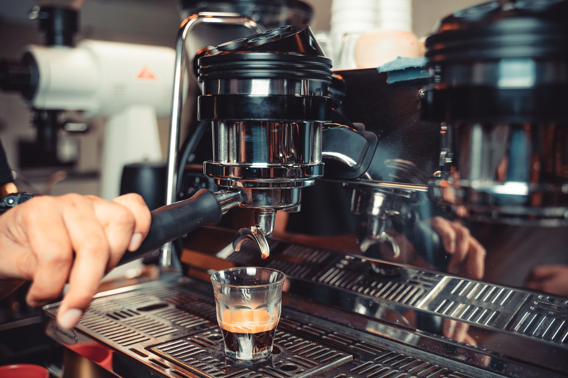 Espresso extracting from a portafilter into two cups